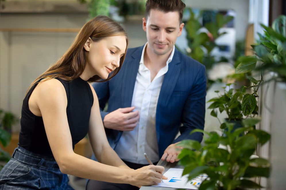 two-business-people-sitting-cafe-working-new-project-using-laptop-young-businesswoman-taking-notes-businessman-working-laptop-computer_35752-1881